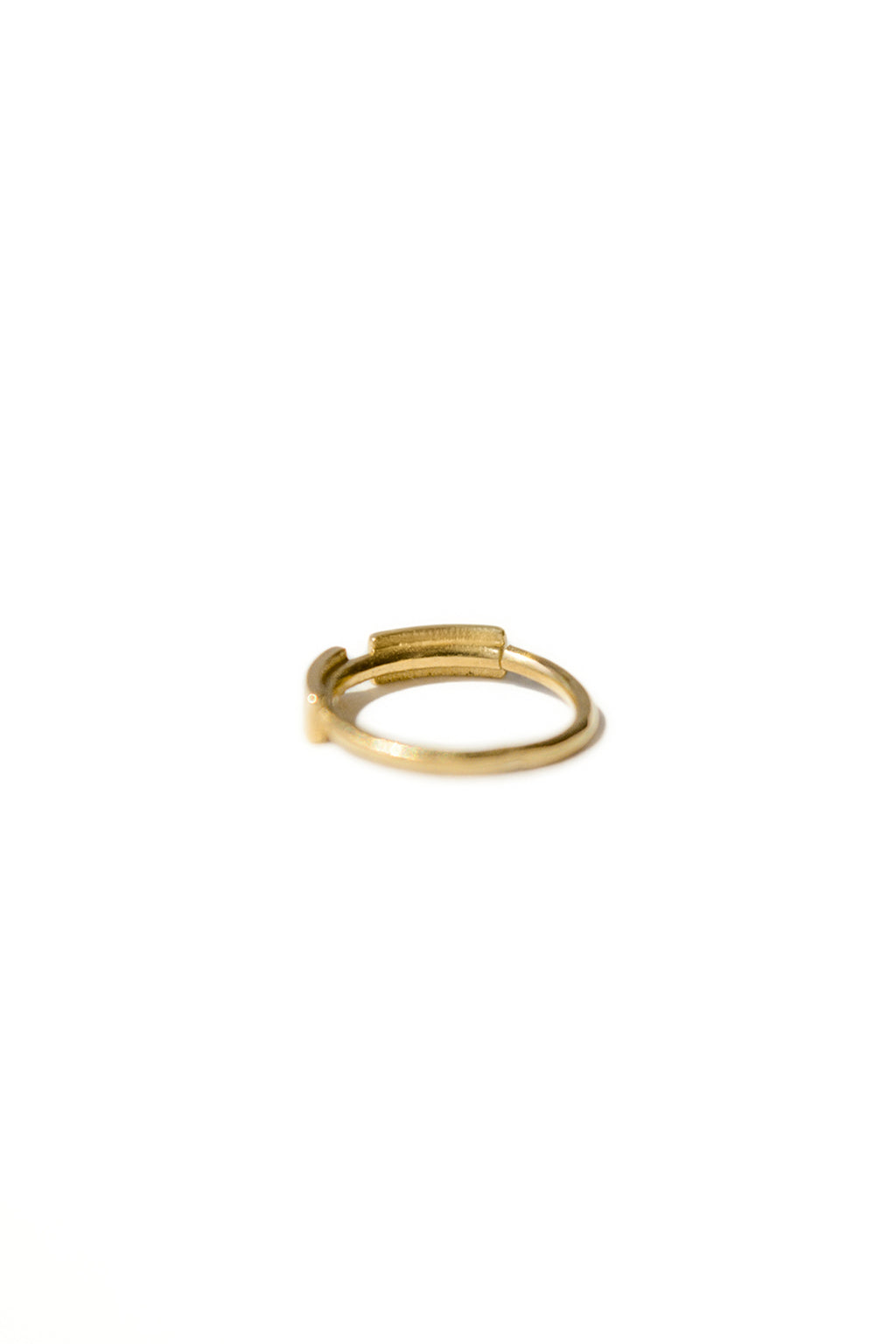 Gold dash line earring in 18k gold, small circular bangle with subtle narrowing in its shape. Designed by Sansoeurs.