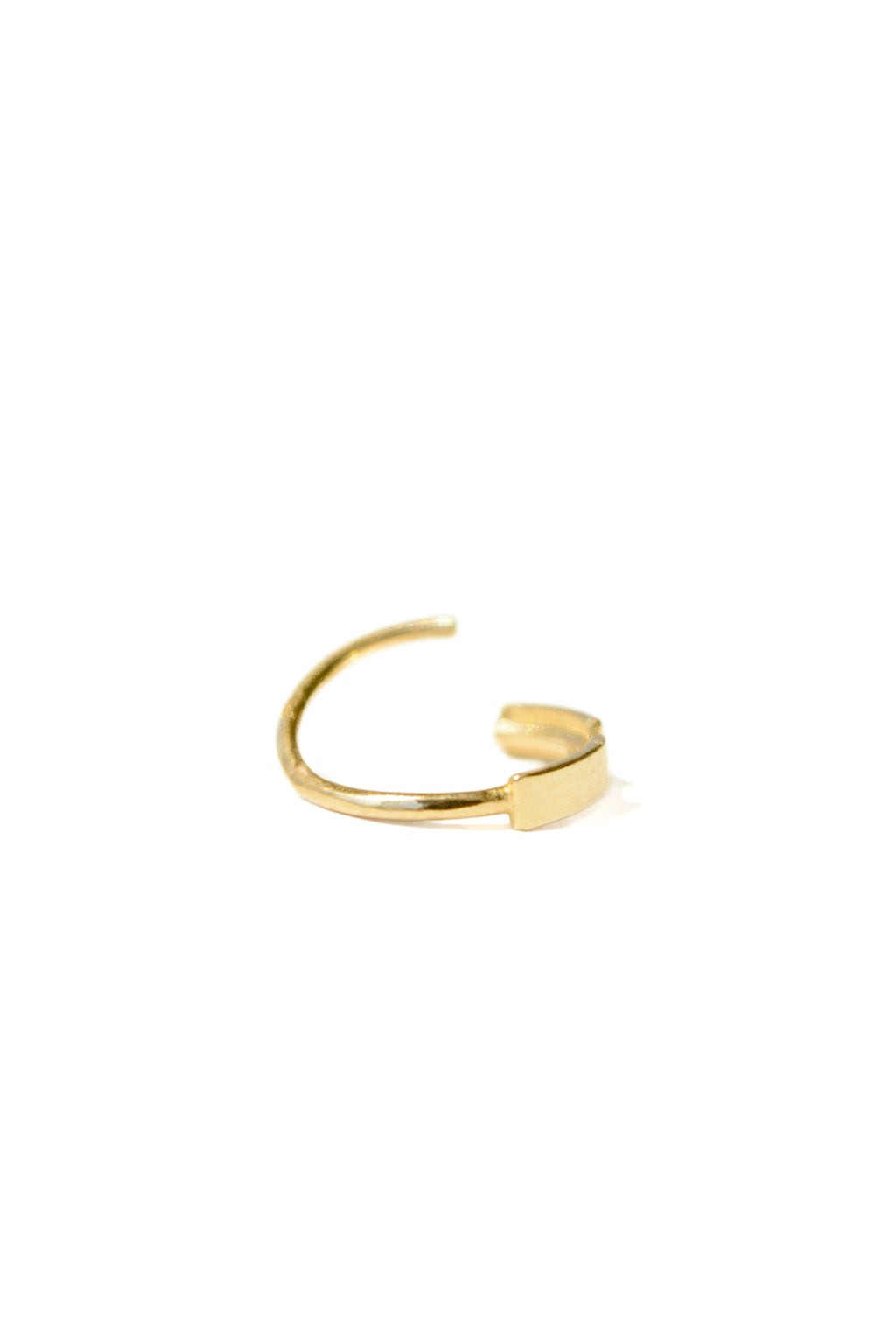Gold dash line opened earring in 18k gold, small circular bangle with subtle narrowing in its shape. Designed by Sansoeurs.