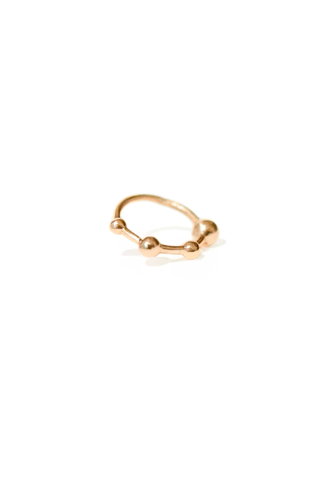18k rose gold mini bangle earring with four sculpted spheres, seen from the front on a white background