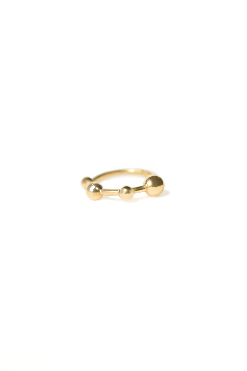 18k yellow gold mini bangle earring with four sculpted spheres, seen from the front on a white background