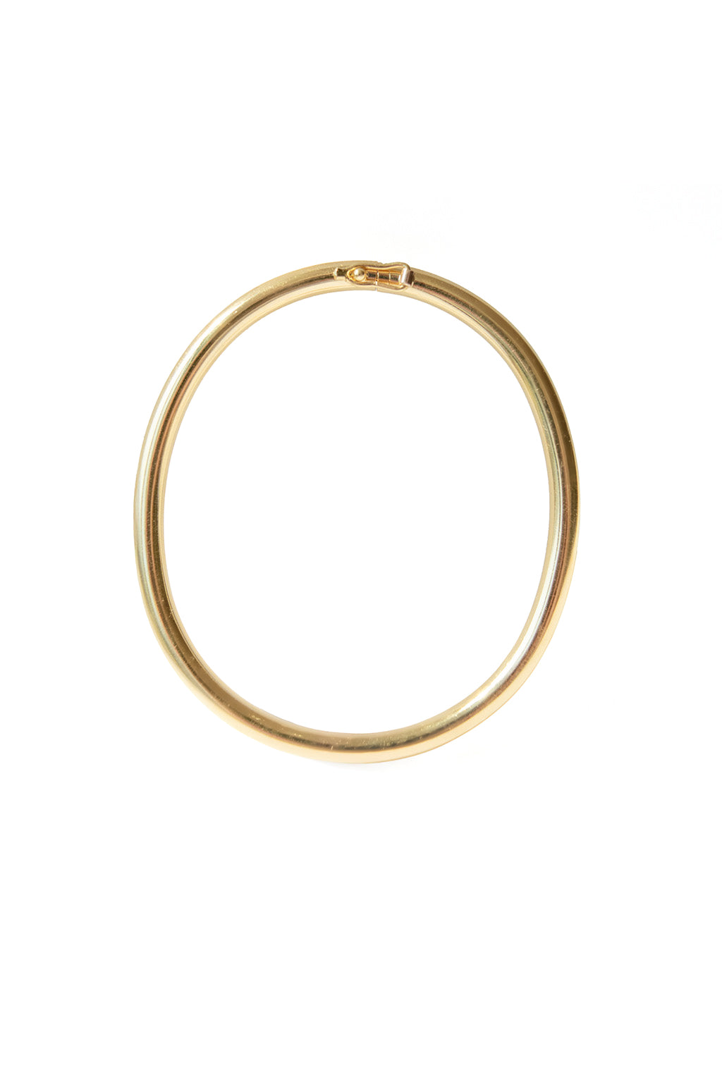 Gold oval bracelet with polished finish on white background