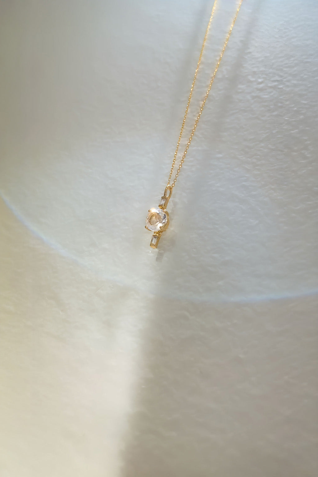 Drop Baguettes Gold Necklace in 18k yellow gold with diamonds and a 5 mm topaz, designed by Sansoeurs.