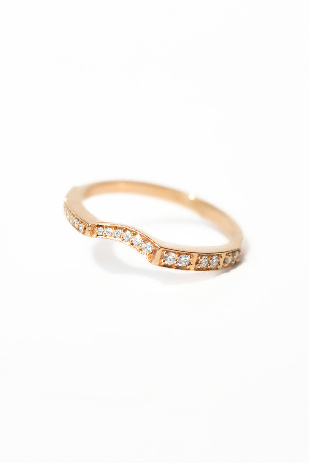 Irregular 18k gold ring with sculptural finish on white background