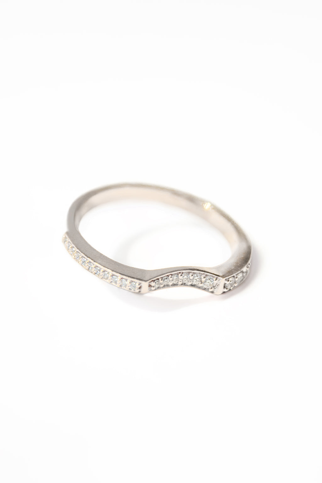 Irregular 18k gold ring with sculptural finish on white background