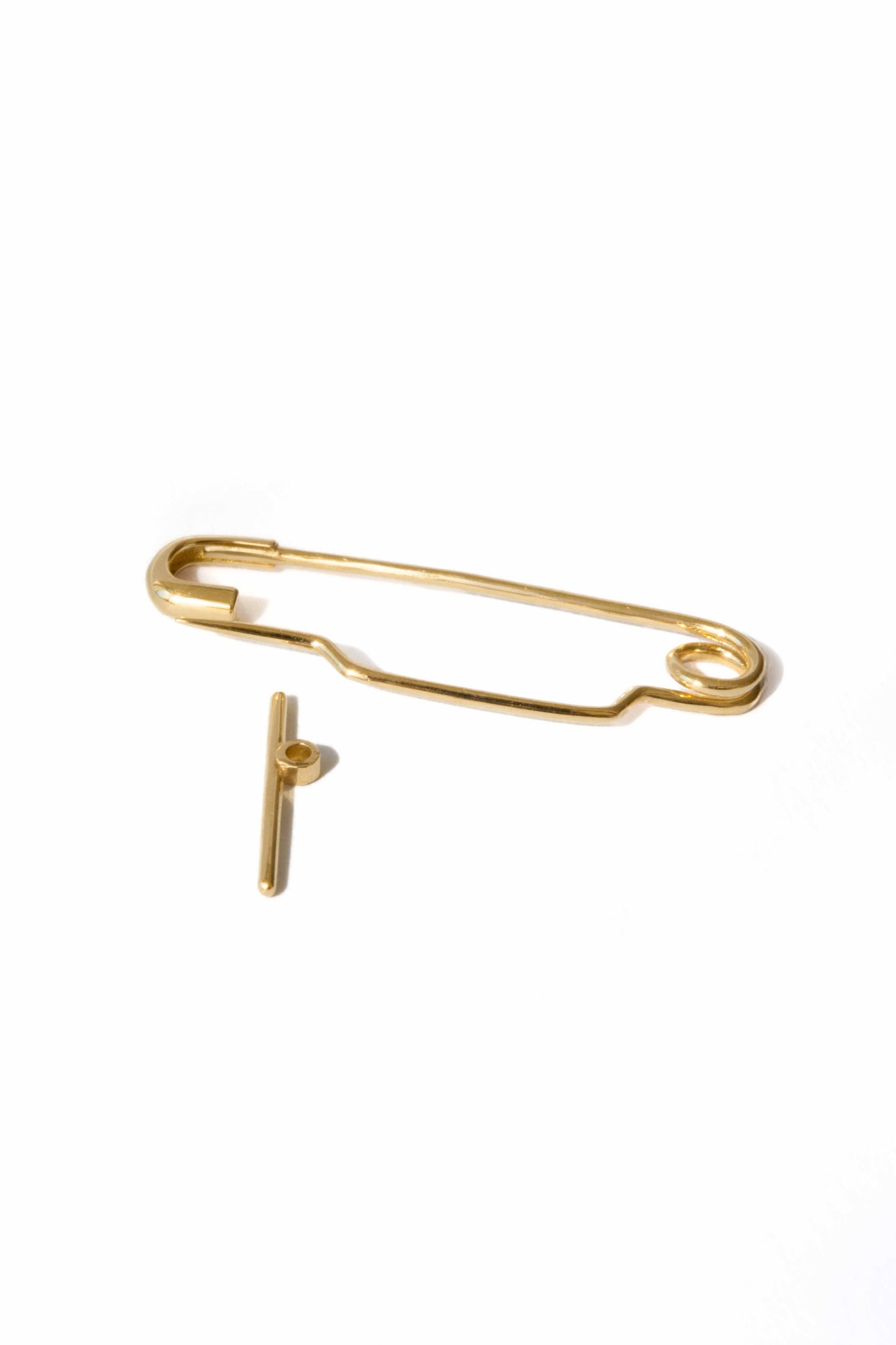 Baby Pin in 18k yellow gold by Sansoeurs, shown opened, bespoke design for a christening day.