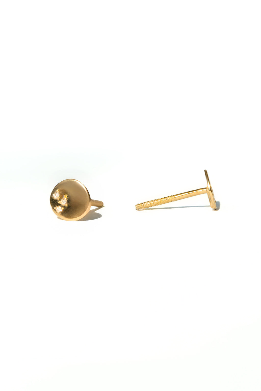 Dots gold and diamonds baby earrings by Sansoeurs, oval gold studs with three diamonds