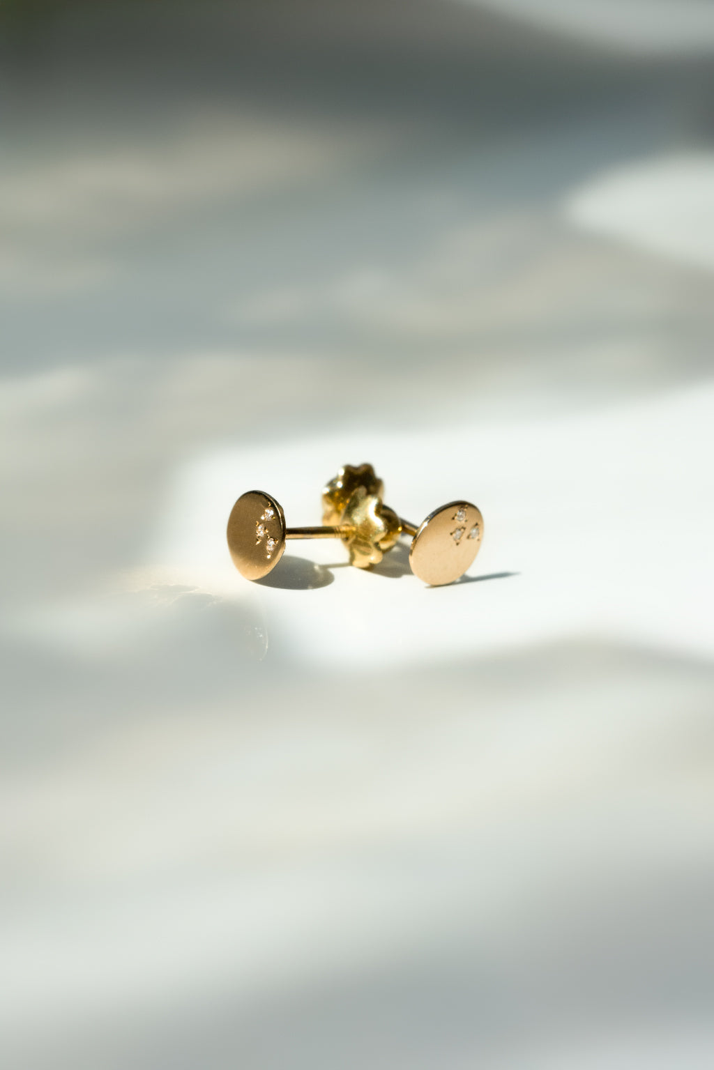 Dots gold and diamonds baby earrings by Sansoeurs, oval gold studs with three diamonds