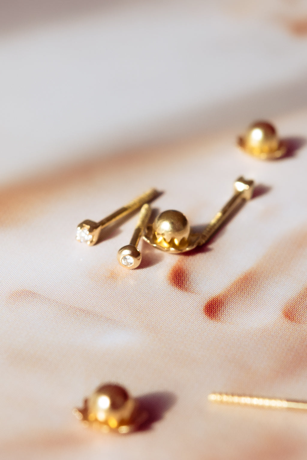 Eye and Box gold and diamond baby earrings by Sansoeurs, diamond set in circular gold bezel
