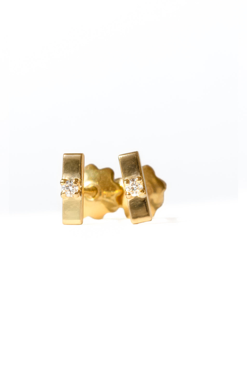 Plaque Tag gold and diamond baby earrings by Sansoeurs, tiny rectangular gold studs with a central diamond