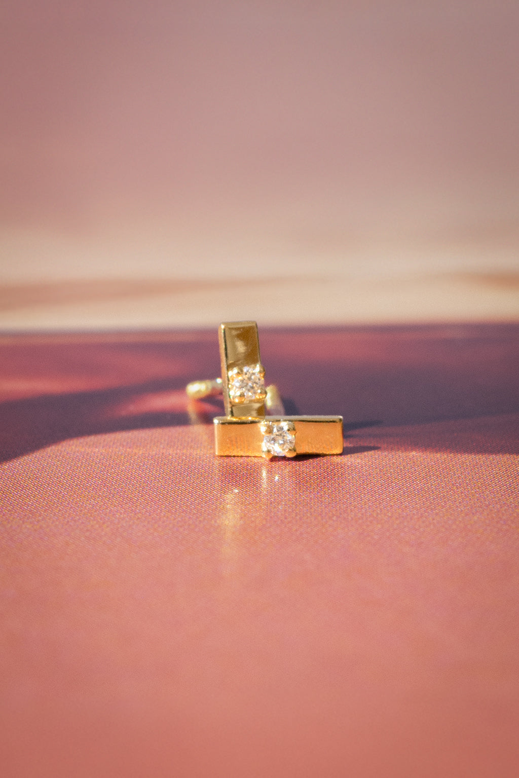 Plaque Tag gold and diamond baby earrings by Sansoeurs, tiny rectangular gold studs with a central diamond