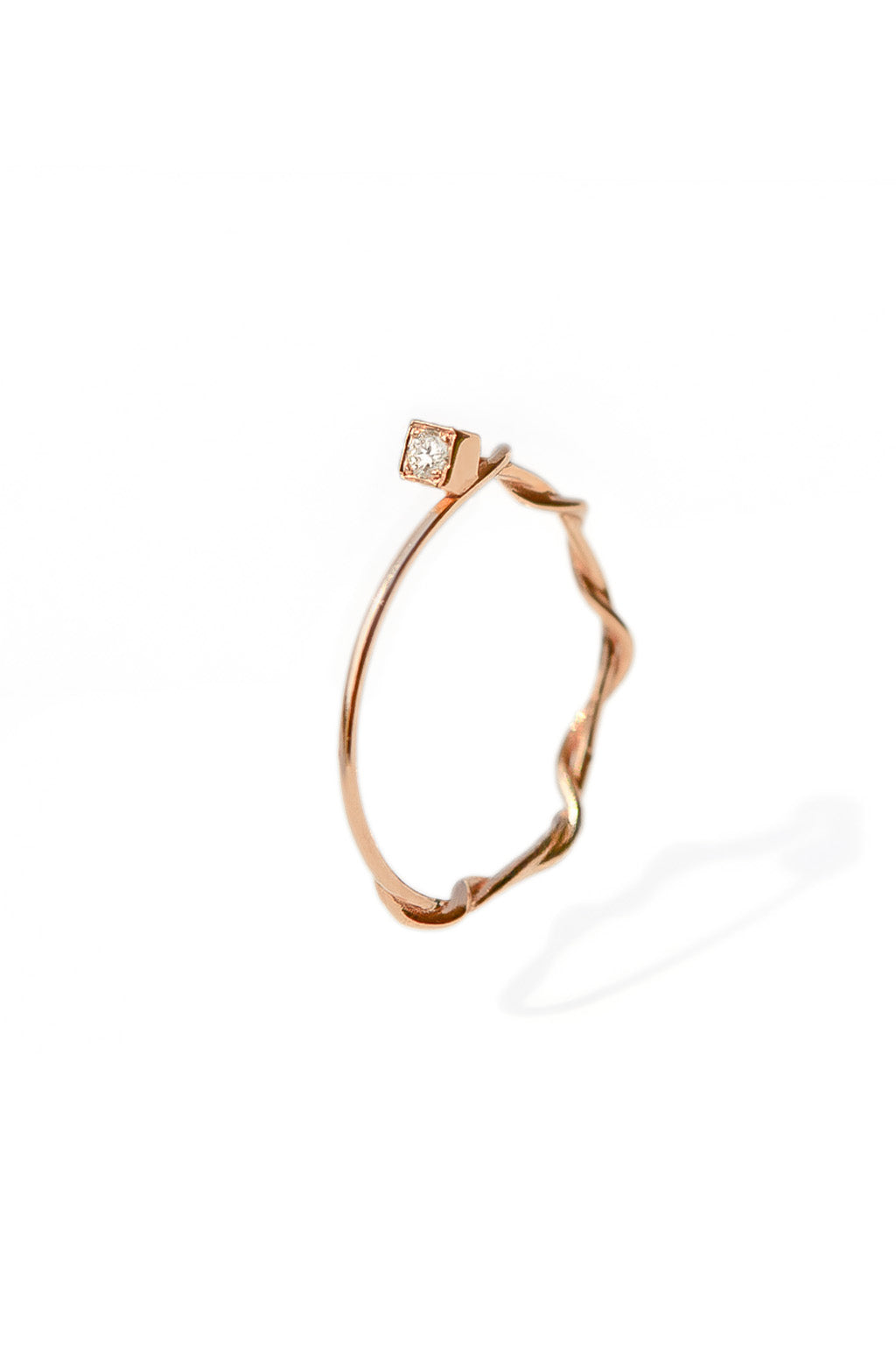 Small Miki 18k gold ring with a 2 mm diamond, featuring a double round band intertwined in the middle and a simple upper band, photographed on white background