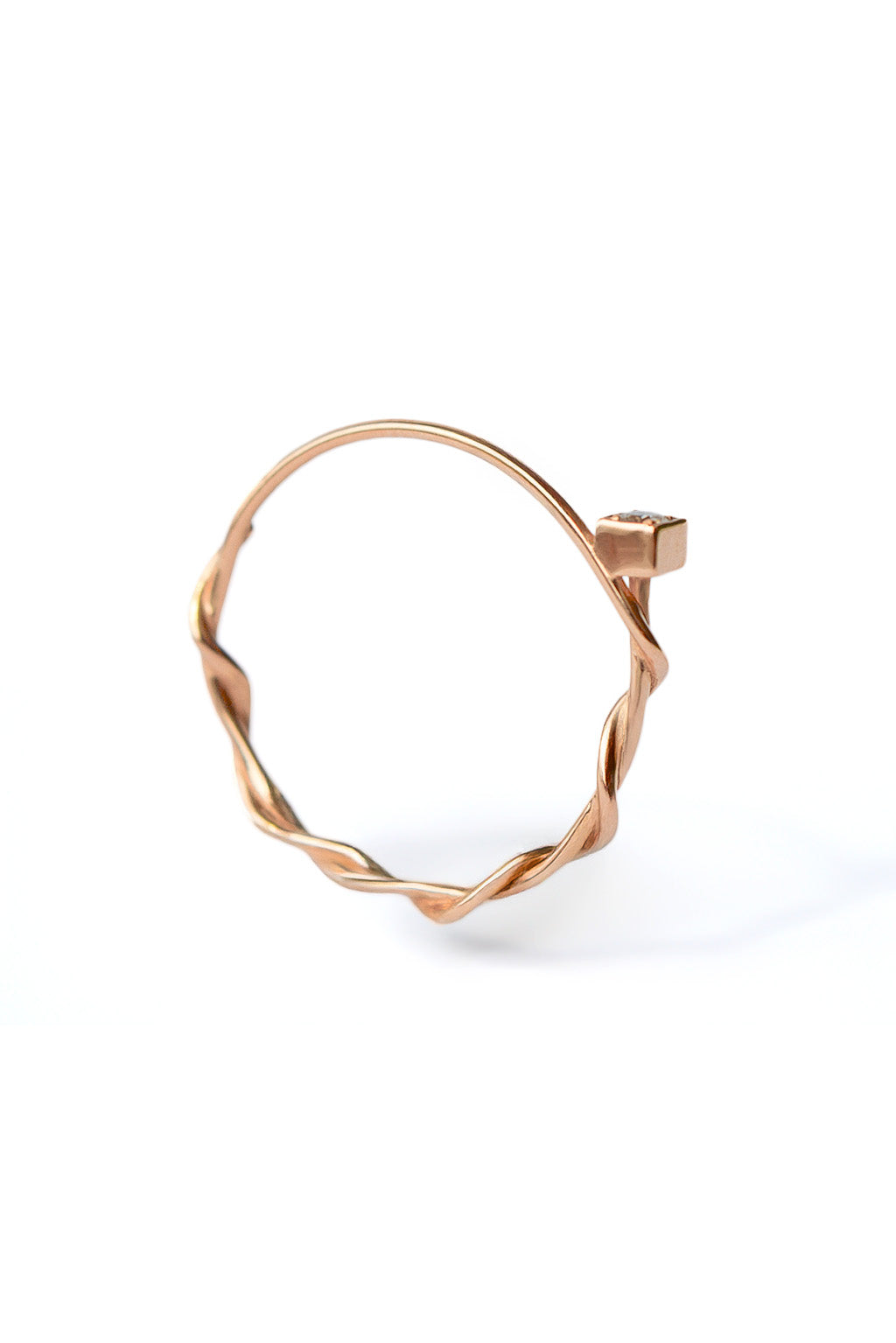 Small Miki 18k gold ring with a 2 mm diamond, featuring a double round band intertwined in the middle and a simple upper band, photographed on white background