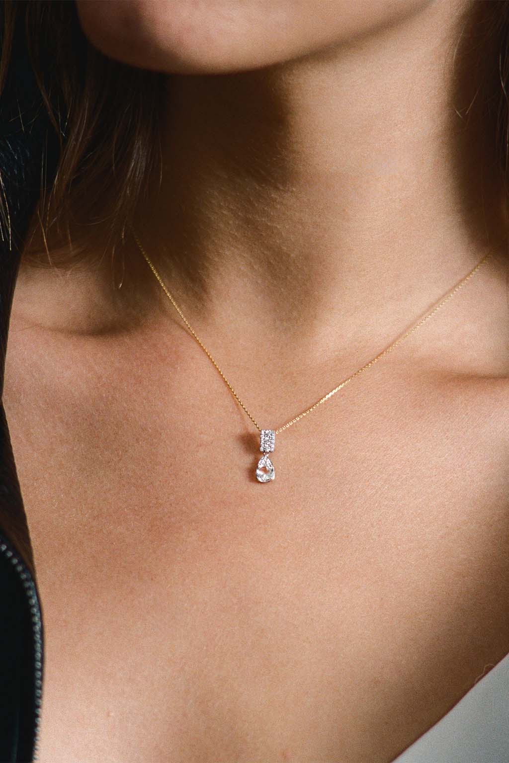 Wife Topaz Pendant in white 18k gold with diamonds and pear-shaped topaz, handcrafted by Sansoeurs, worn on model.
