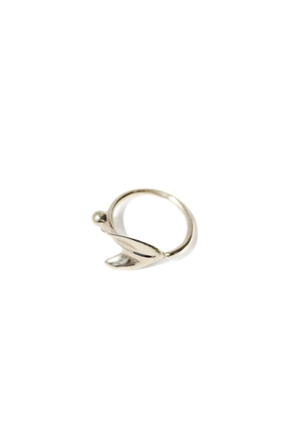 Close-up of the Floral Mini Bangle in 18k gold by Sansoeurs, featuring an arrow-like organic form and small sphere
