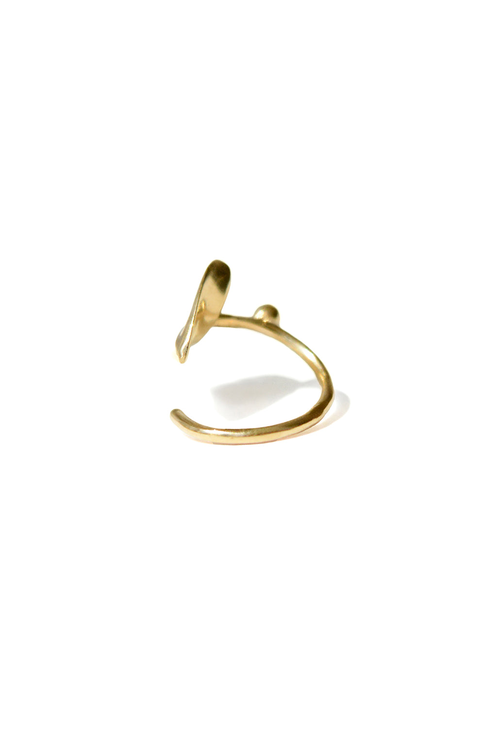 Close-up of the opened Floral Mini Bangle in 18k gold by Sansoeurs, featuring an arrow-like organic form and small sphere
