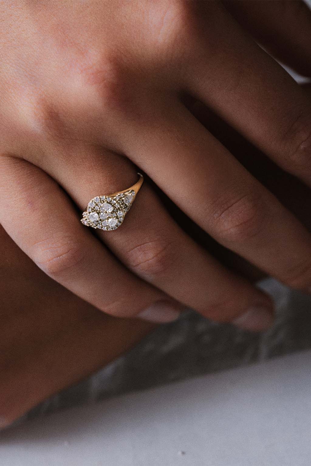 Sugar Signet Gold Ring in 18k gold with diamonds, handcrafted by Sansoeurs, worn on model’s hand.
