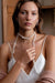 Wife Topaz Pendant in white 18k gold with diamonds and pear-shaped topaz, handcrafted by Sansoeurs, worn on model.