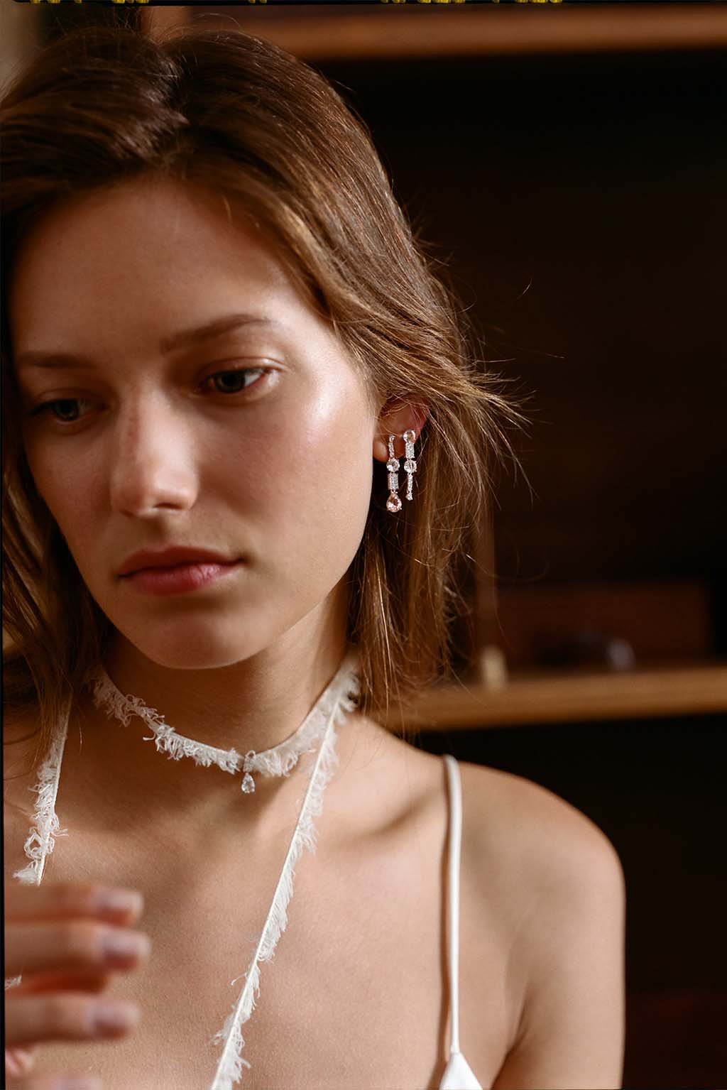 Long Wife Morganite Gold Earring in 18k white gold with diamonds, topaz and morganite, designed by Sansoeurs, worn on model.
