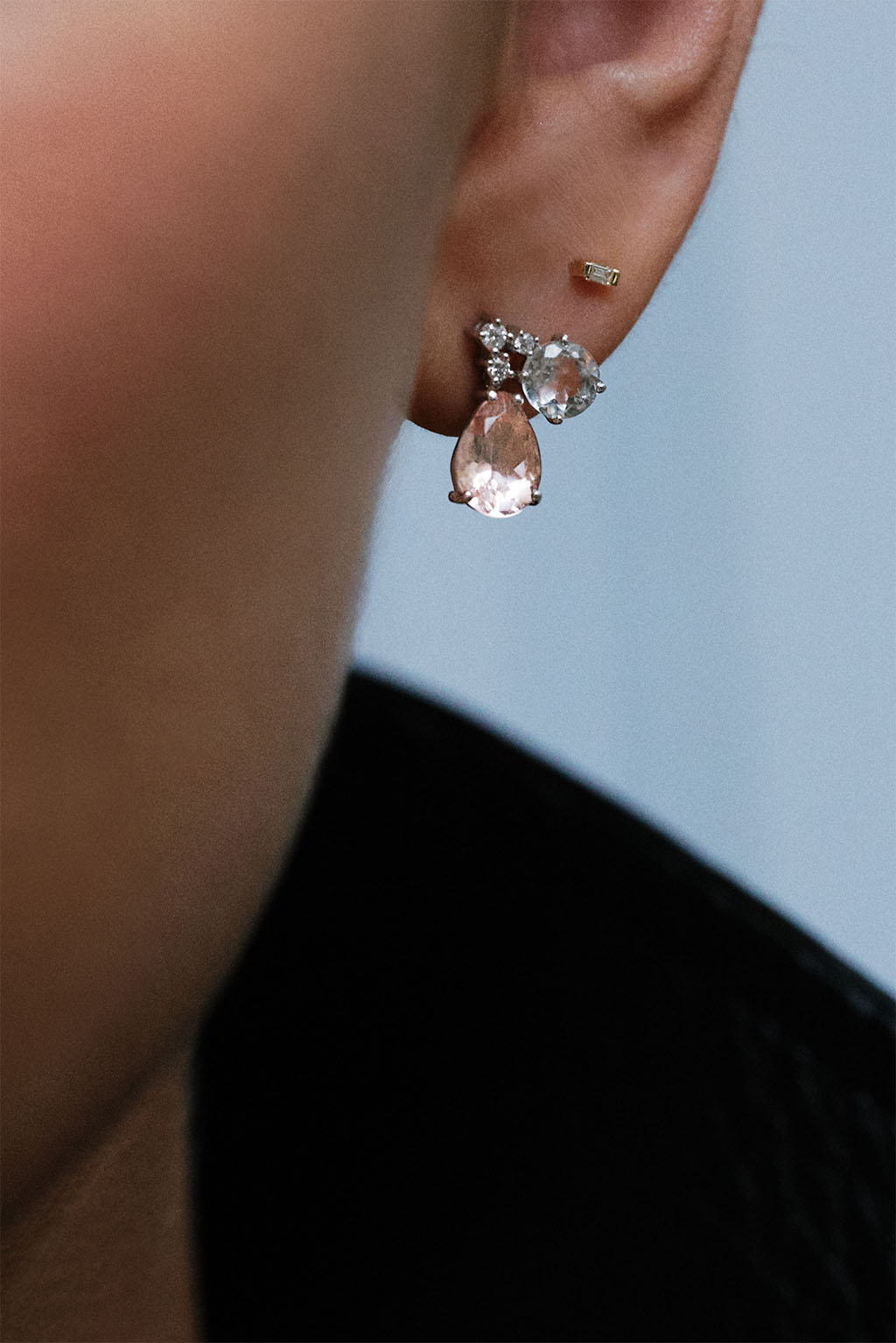 Model wearing the Mobile Topaz Morganite earring in 18k white gold with topaz, morganite, and G VS diamonds by Sansoeurs.