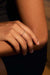 Model wearing the Irregular 18k gold ring with diamonds. Its organic silhouette follows the contour of the finger in a soft, fluid gesture.