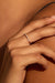 Model wearing the Irregular 18k gold ring with diamonds. Its organic silhouette follows the contour of the finger in a soft, fluid gesture.
