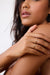 Model wearing the Moi-Moi ring in 18k gold. Two mirrored diamond-set sections trace the finger with a soft repetition that emphasizes the sense of connection.