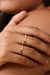Model wearing the Moi-Moi ring in 18k gold. Two mirrored diamond-set sections trace the finger with a soft repetition that emphasizes the sense of connection.