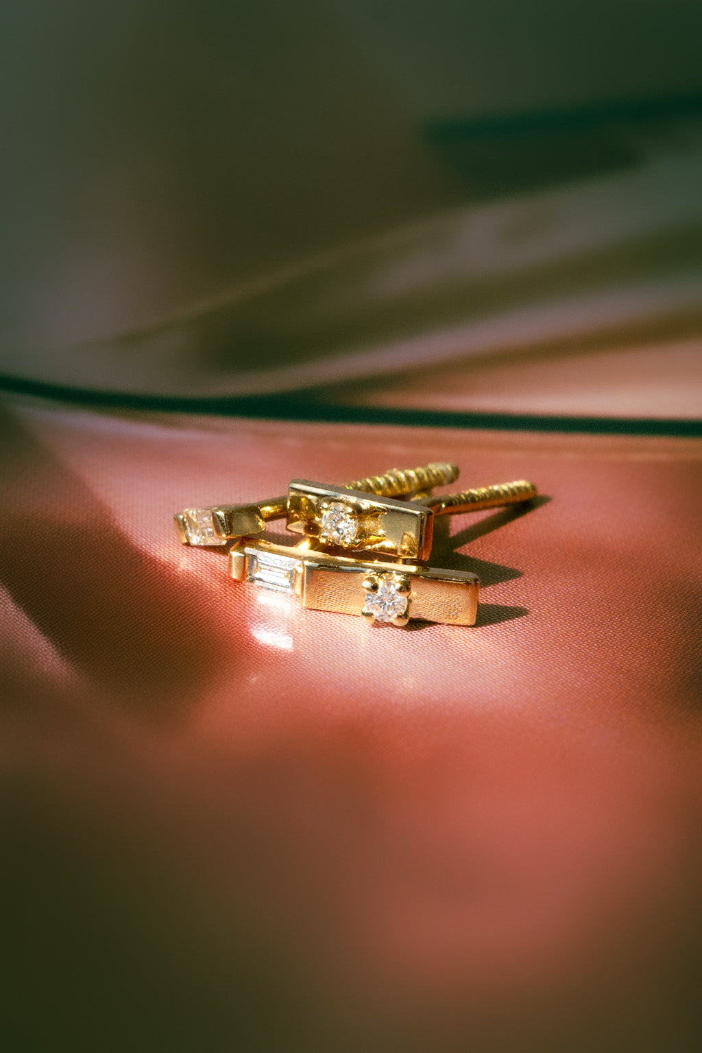 Baguette and Plaque tag gold and diamond baby earrings by Sansoeurs, diamond set between two small gold plates