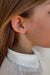 Blond child wearing a single Baby Box 1'7 earring in 18k yellow gold with diamonds by Sansoeurs, visible on one ear.