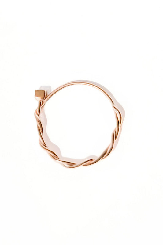 Small Miki 18k gold ring with a 2 mm diamond, featuring a double round band intertwined in the middle and a simple upper band, photographed on white background