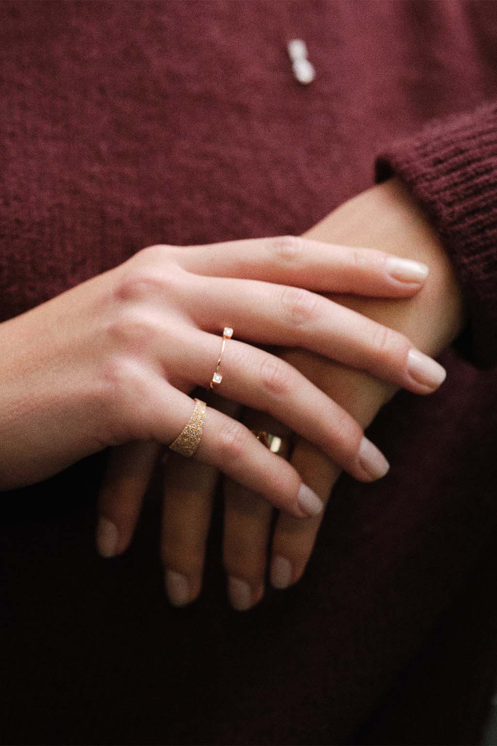 Small Miki Two Diamonds Gold Ring in 18k rose gold, handcrafted by Sansoeurs, worn on model’s hand.