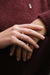 Small Miki Two Diamonds Gold Ring in 18k rose gold, handcrafted by Sansoeurs, worn on model’s hand.
