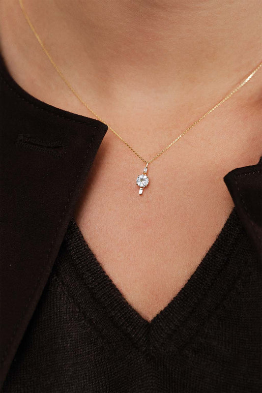 Model wearing the 18k gold topaz necklace by Sansoeurs, featuring a contemporary fine-jewelry design.